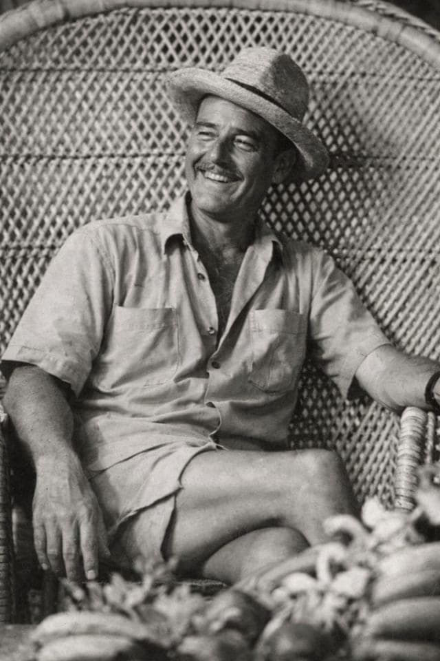 Photograph of Donn Beach, born Ernest Raymond Beaumont Gantt, seated in a wicker chair in a straw hat.